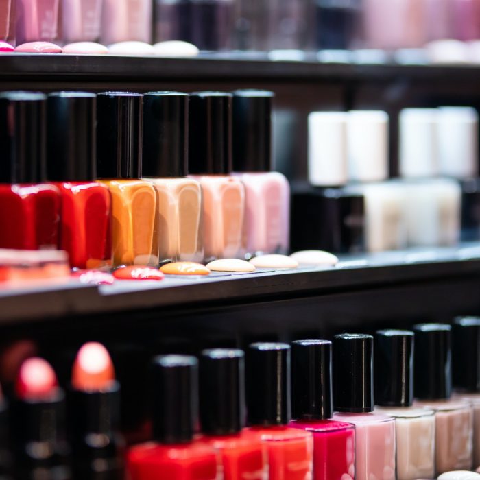 Set of nail polish on shelves in cosmetics beauty store